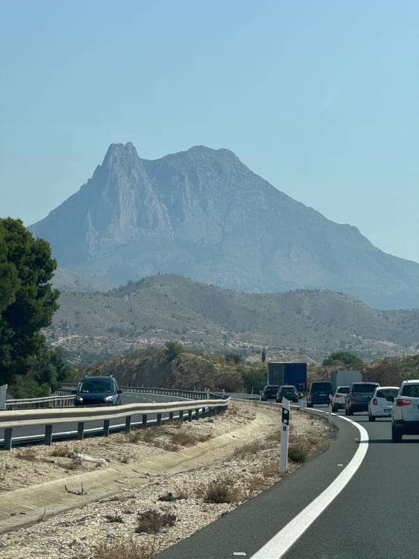 Highway traffic crawls through Villajoyosa's arid mountain corridor