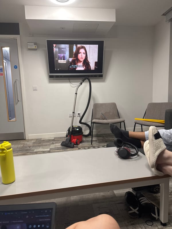Two people relax in Hull common room late evening