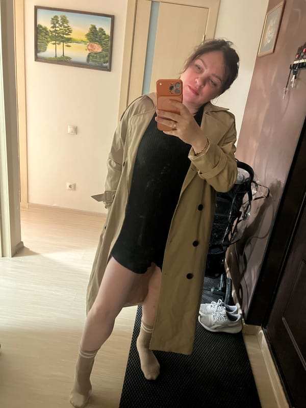 Woman takes selfie with orange phone in Perm apartment