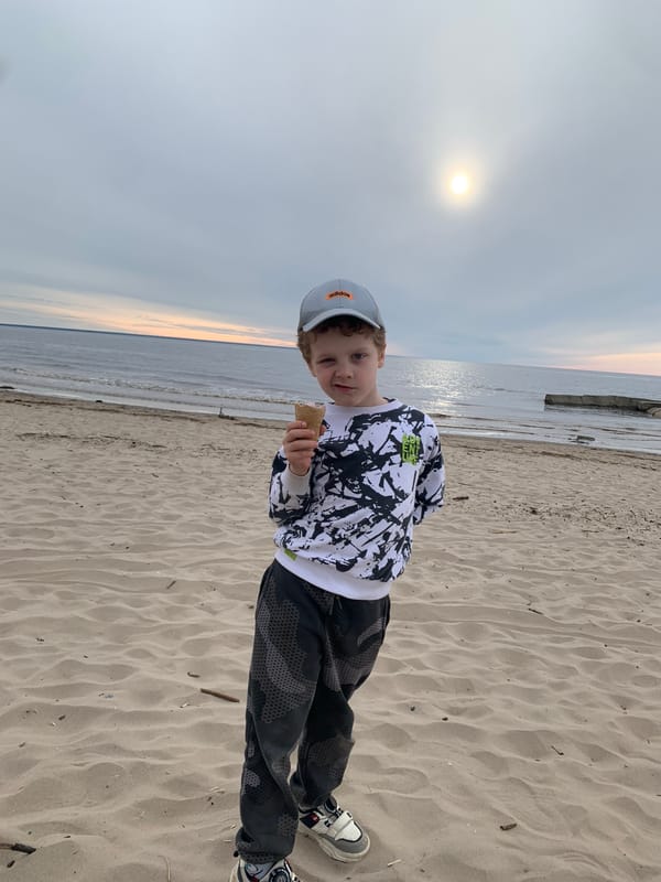 Boy enjoys sunset beach moment in Severodvinsk