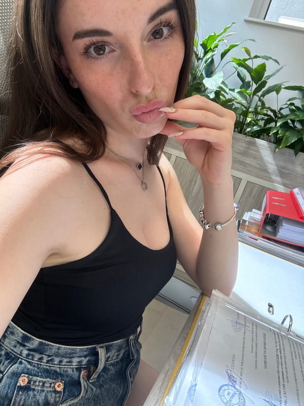 Relaxed indoor selfie session reflected in a laptop screen