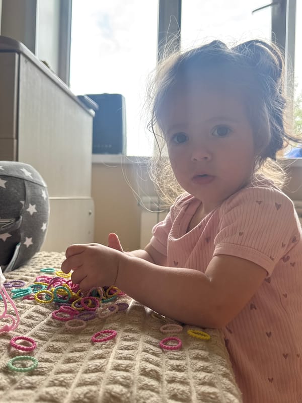 Toddler plays with hair ties in Beryozovka, Russia