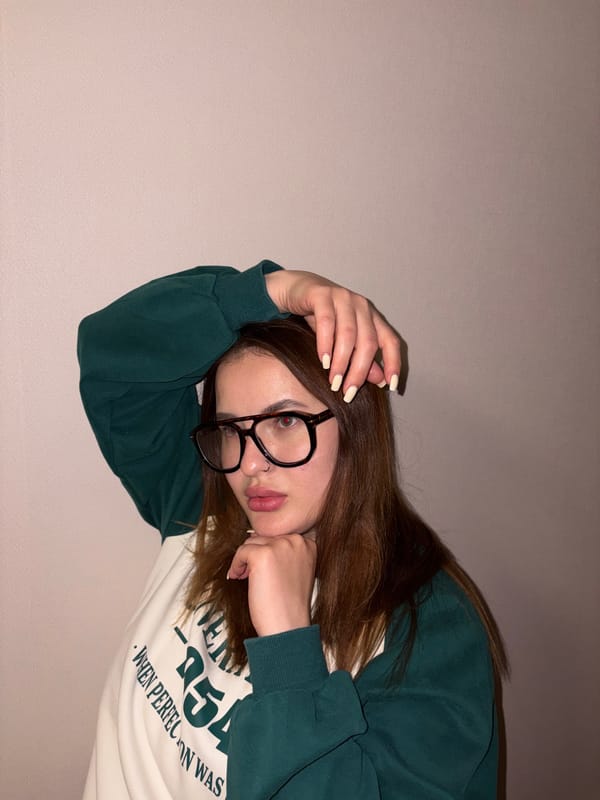 Portrait session documented: woman with glasses photographed indoors