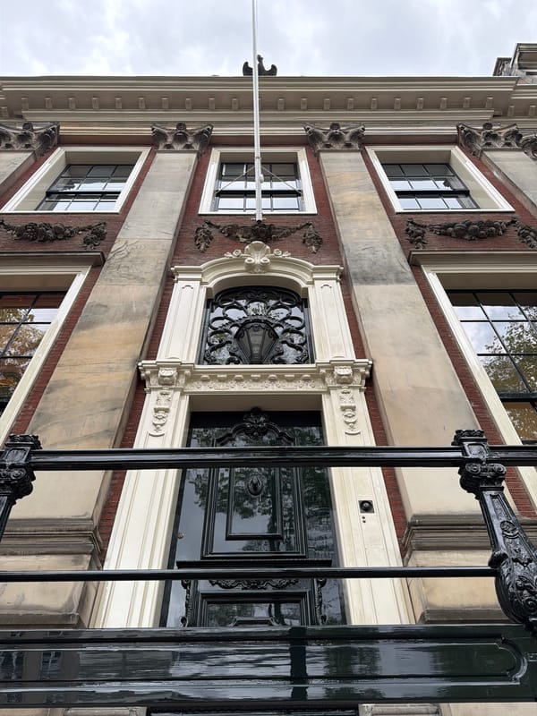 Amsterdam canal district architecture and street life on a cloudy morning