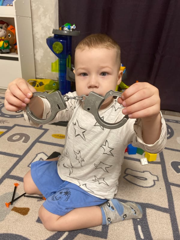 Child plays with toy police gear in Sochi home