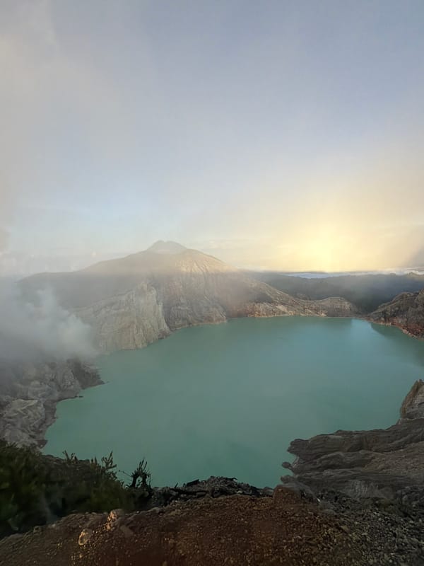 Sunrise crowds gather at Kawah Ijen's crater rim in East Java