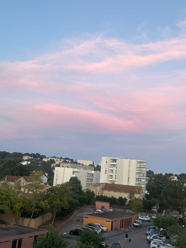 Aerial view of city neighborhood under pastel evening sky