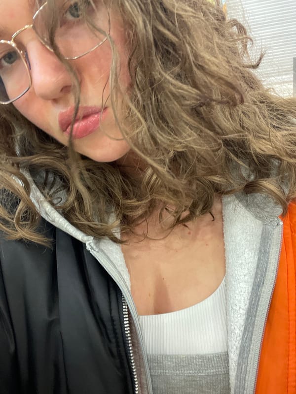 Person takes selfie in Moscow wearing glasses and tank top