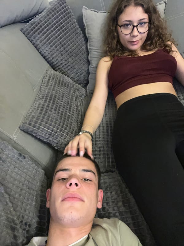 Couple enjoys pizza and TV evening at home in Plovdiv