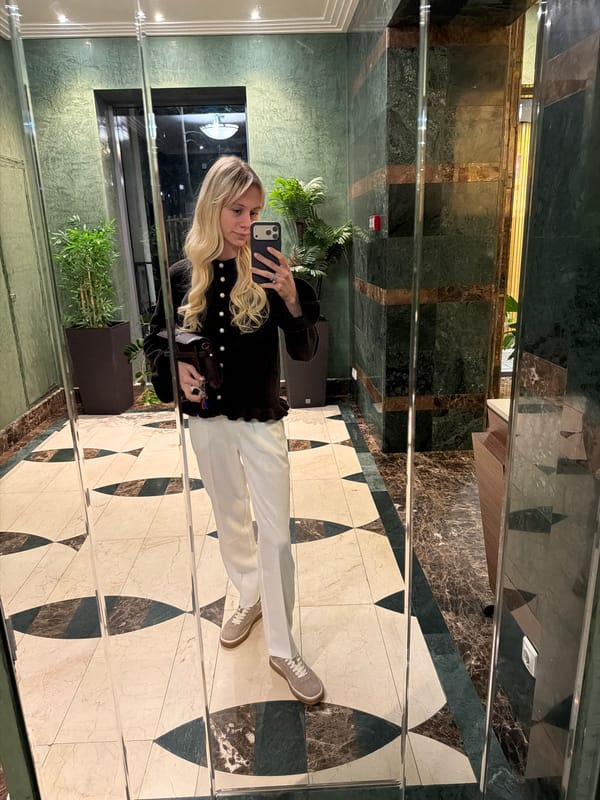 Woman takes selfie in mirrored elevator in Moscow