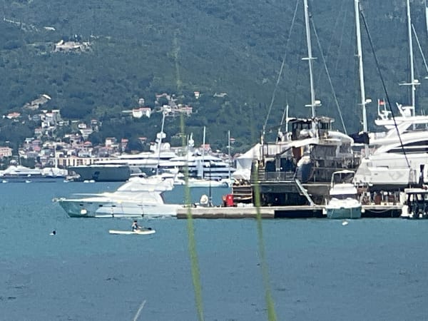 Calm morning on the Bay of Kotor: yachts, campers, and flat water