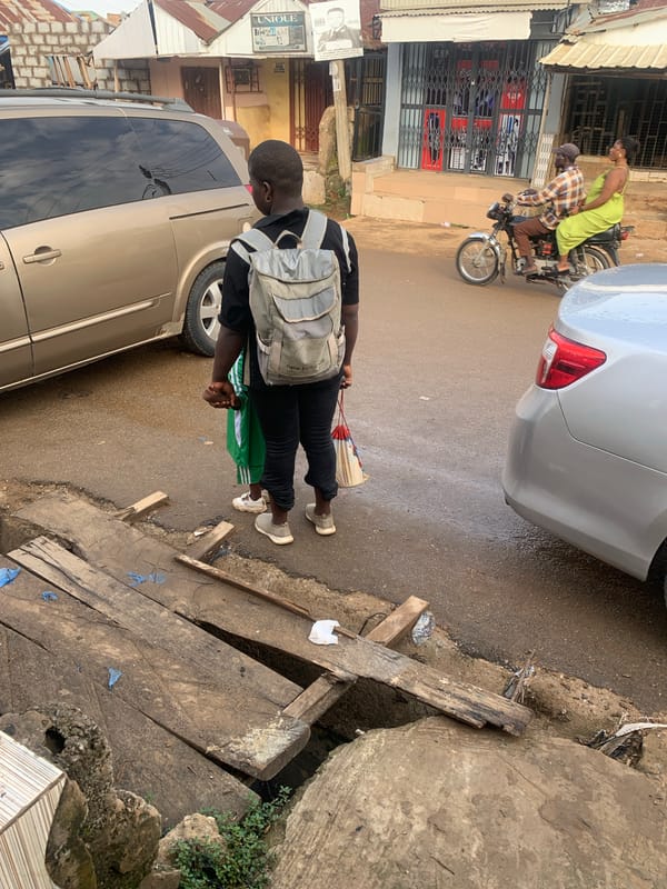 Morning street life in Abuja after rainfall, kids and commuters out
