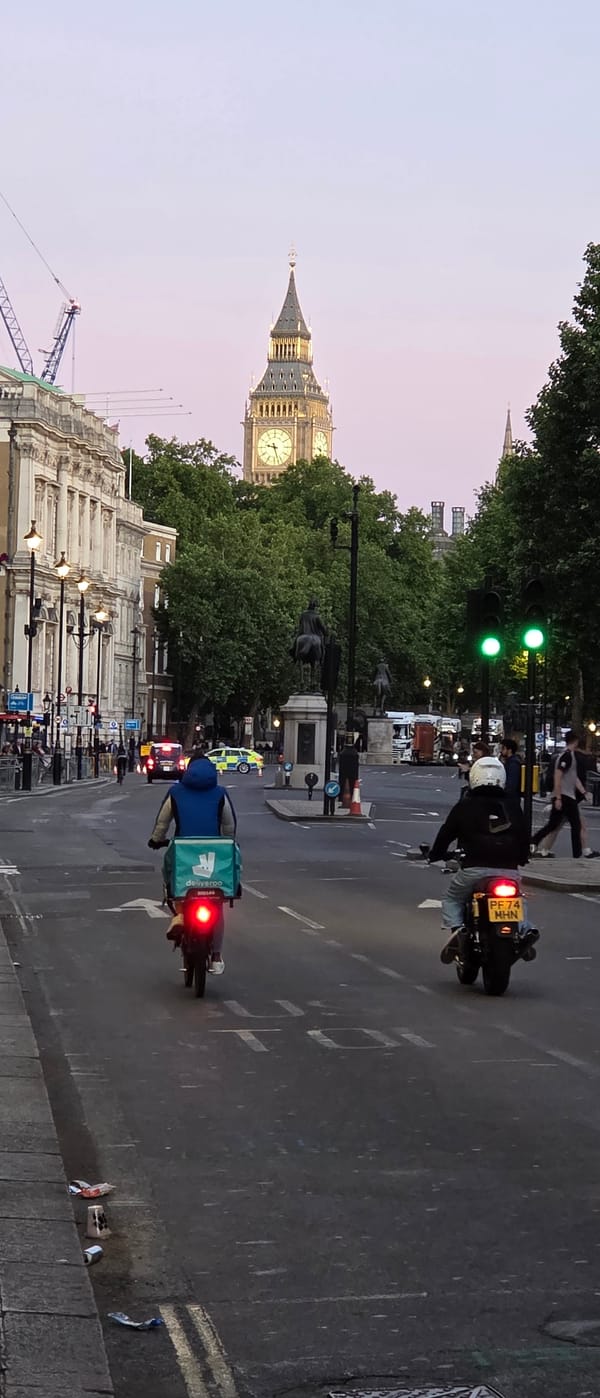 Big Ben illuminated at twilight draws multiple observers
