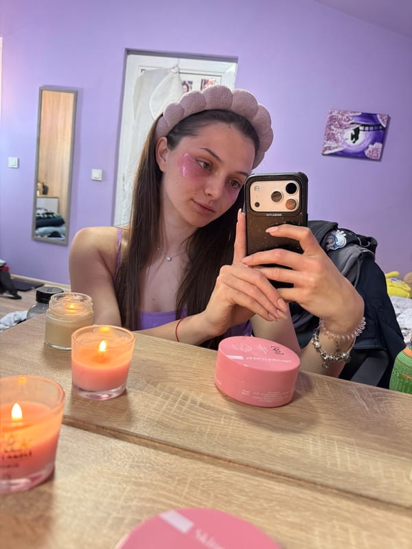 Woman Takes Selfie With Eye Patches in Purple Room