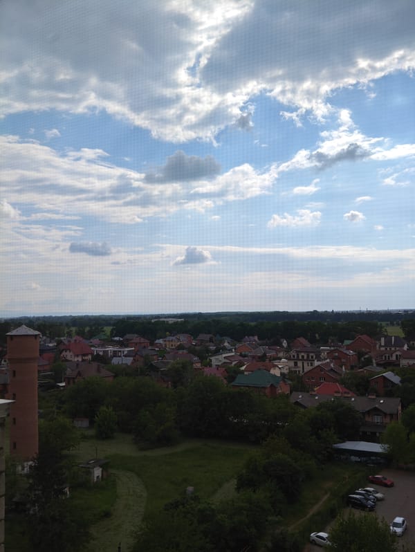 Aerial view captures urban landscape under partly cloudy skies