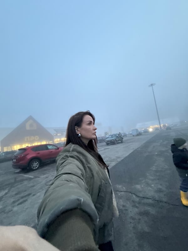 Woman stands in foggy parking lot outside Izhevsk store