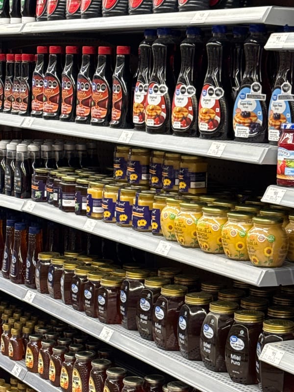 Grocery store stocks syrup and honey aisle in Puebla
