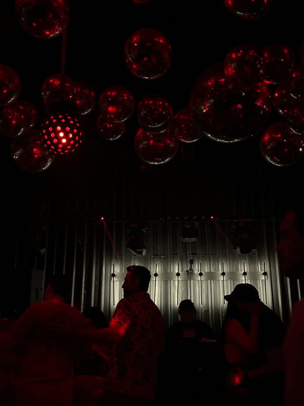 Nightclub scene with red-lit disco balls observed in Coatzacoalcos