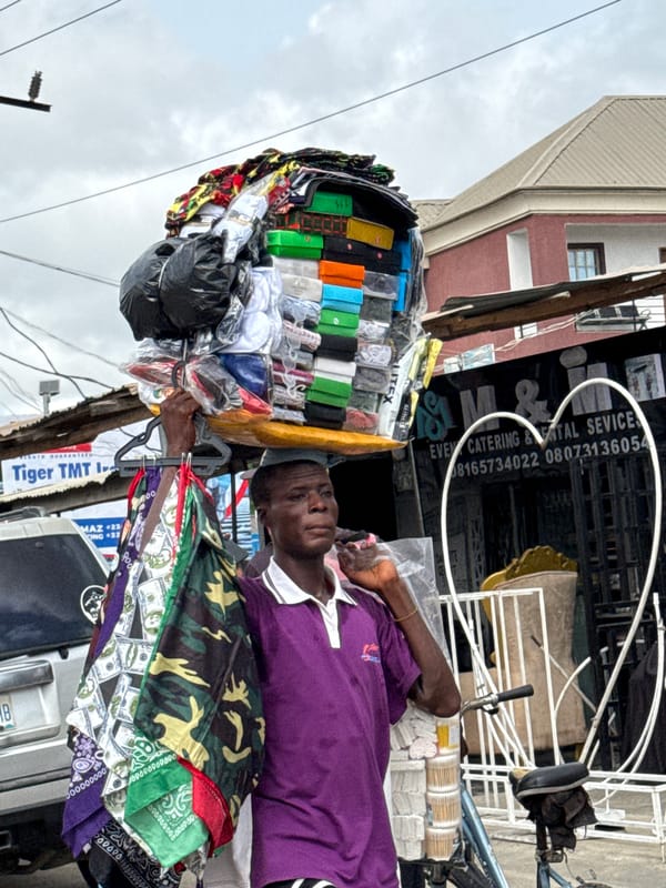 Vendor rests during goods transport in Ado, Nigeria