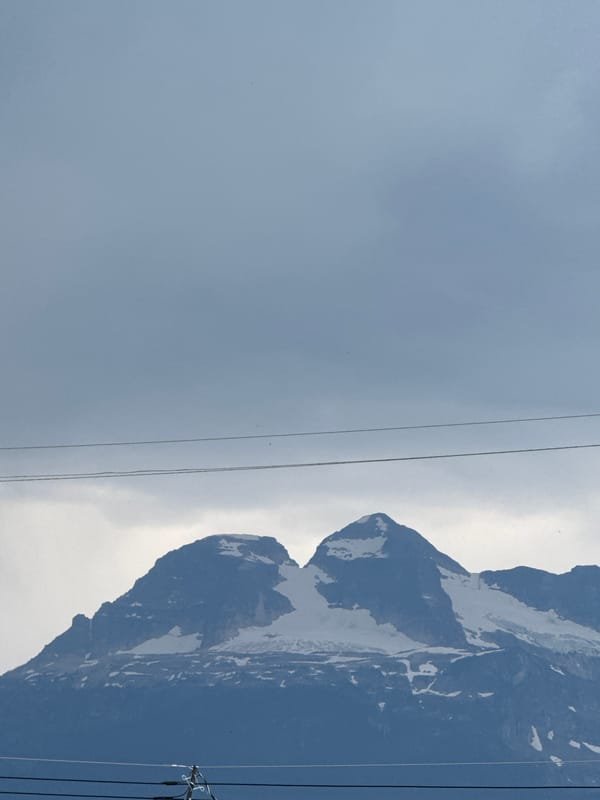 Mount Begbie's snowy peaks under a gray Revelstoke sky