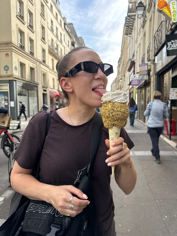 Woman enjoys ice cream on Paris street