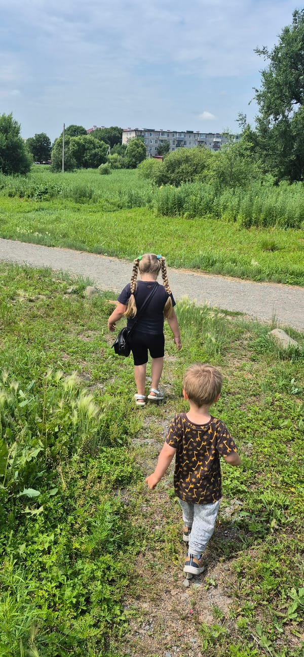 Two kids exploring a urban park and playground area