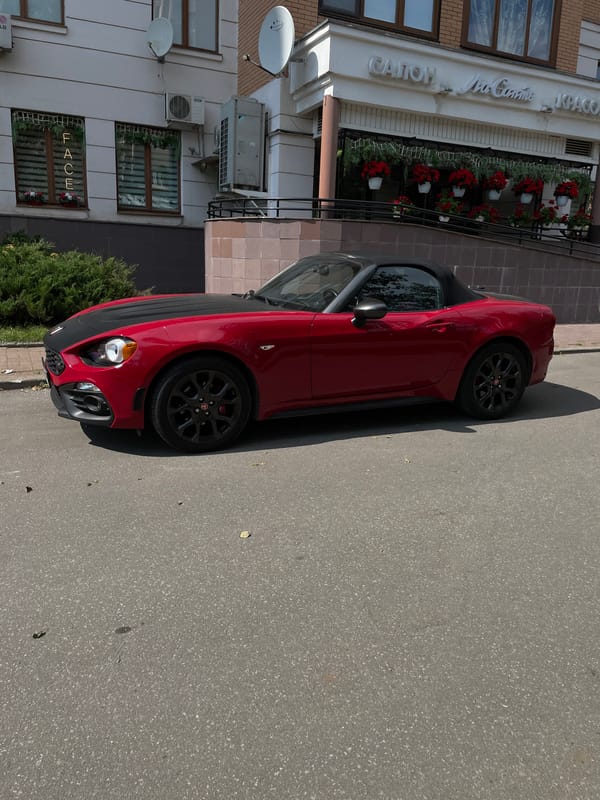 Red convertible parked outside a Moscow commercial building