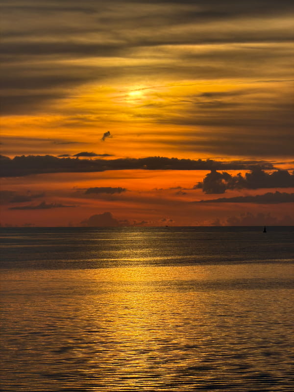 Koh Phangan sunset draws boats, jet skis, and shoreside life