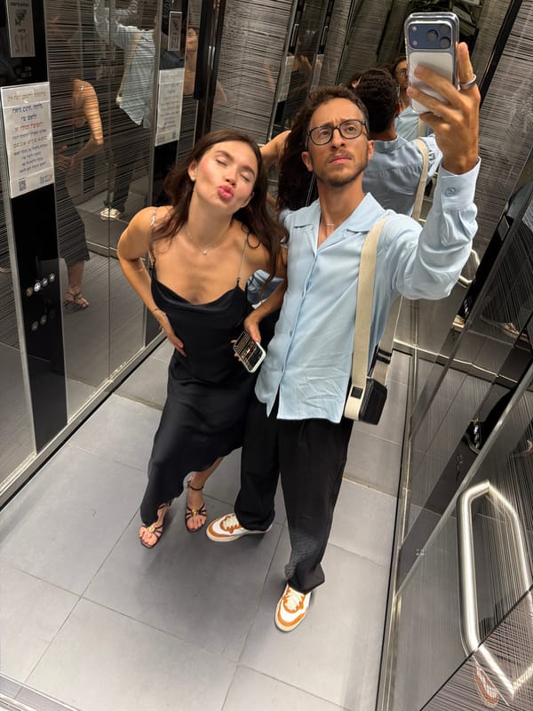 Elevator mirror selfie, black slip dress and strappy heels