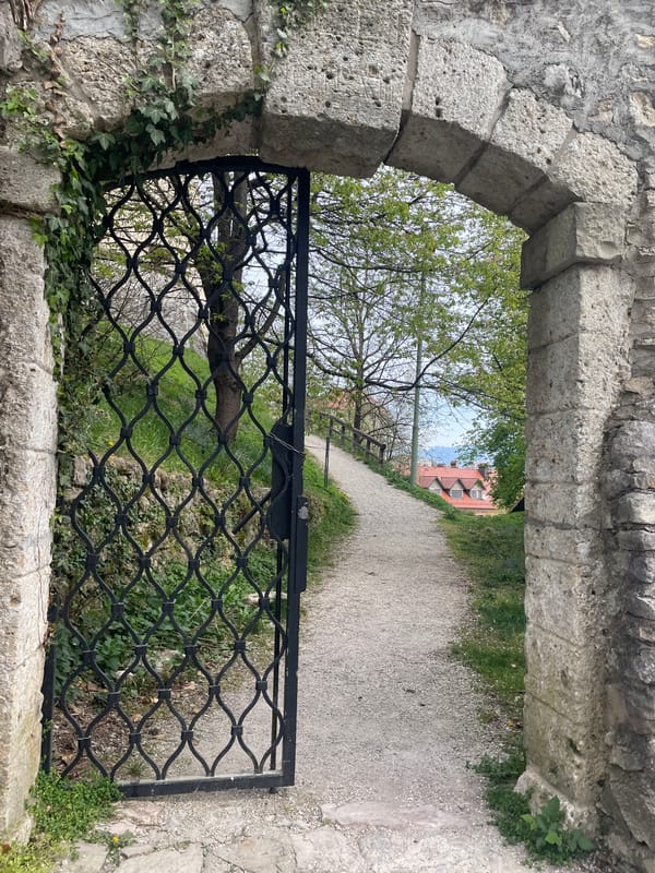 Tourist documents historic Škofja Loka landmarks during morning walk