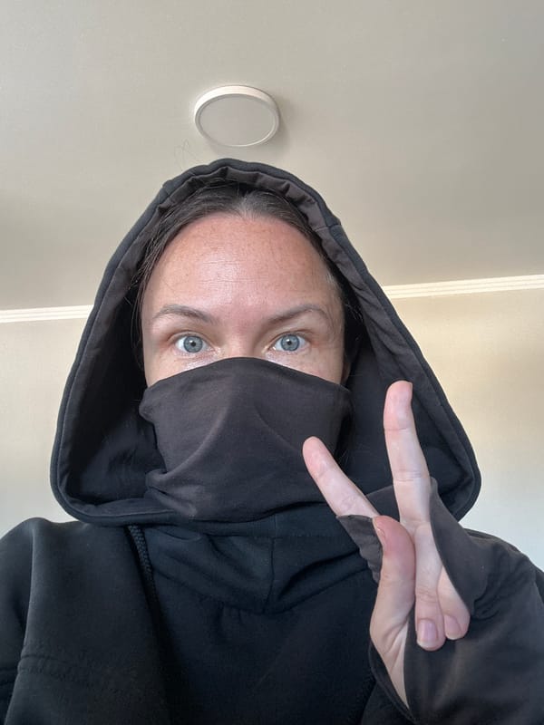Hooded figure photographed with face covered in Florianópolis