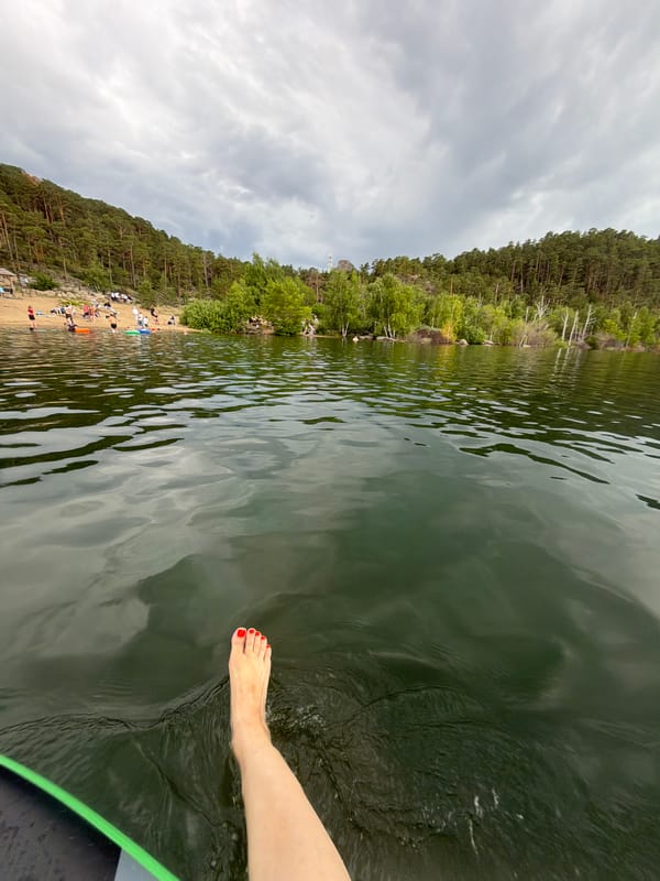 Paddleboarder enjoys Lake Burabay amid cloudy Kazakhstan morning