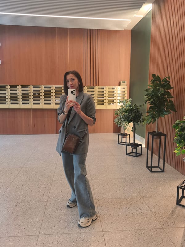 Woman takes selfie in modern building lobby in Perm
