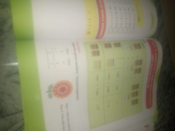 Early math workbook session on a floor in rural Nigeria