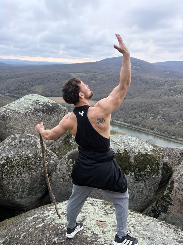 Man poses with staff at Bulgarian megalithic sanctuary