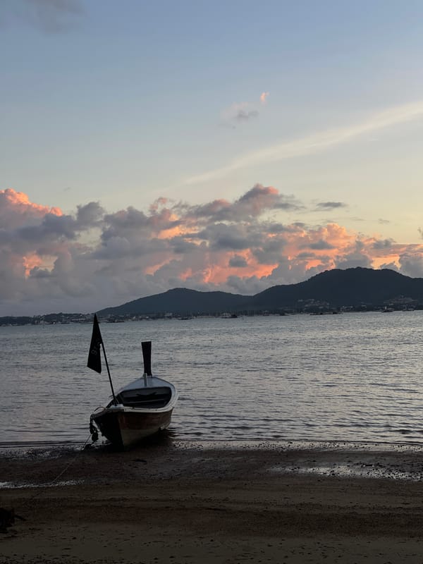 Dusk at Grove Phuket's waterfront, boats and fairy lights