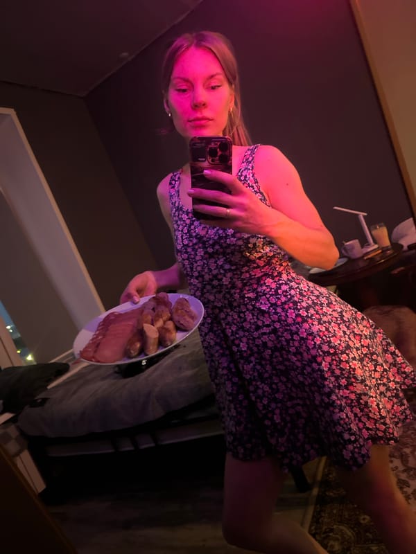 Woman poses with meat platter in Blagoveshchensk bedroom selfie