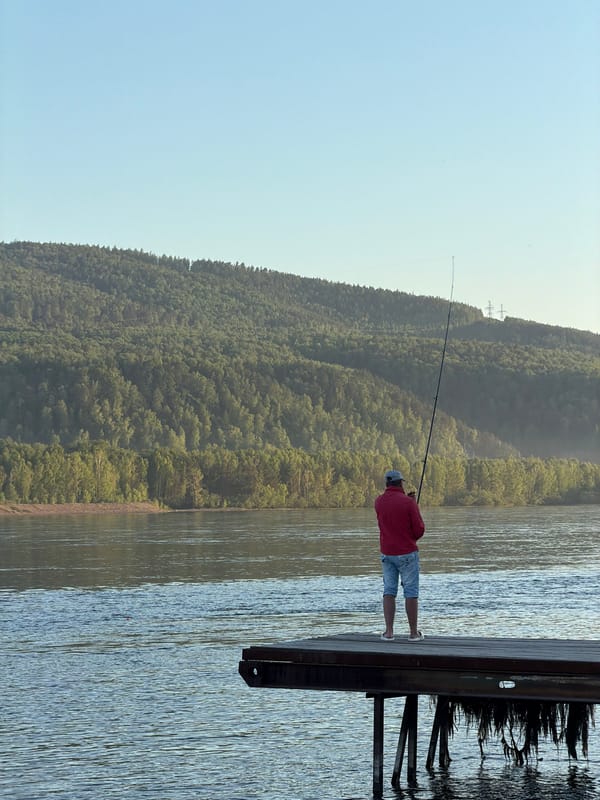 Man fishing on Yenisei River pier in Krasnoyarsk