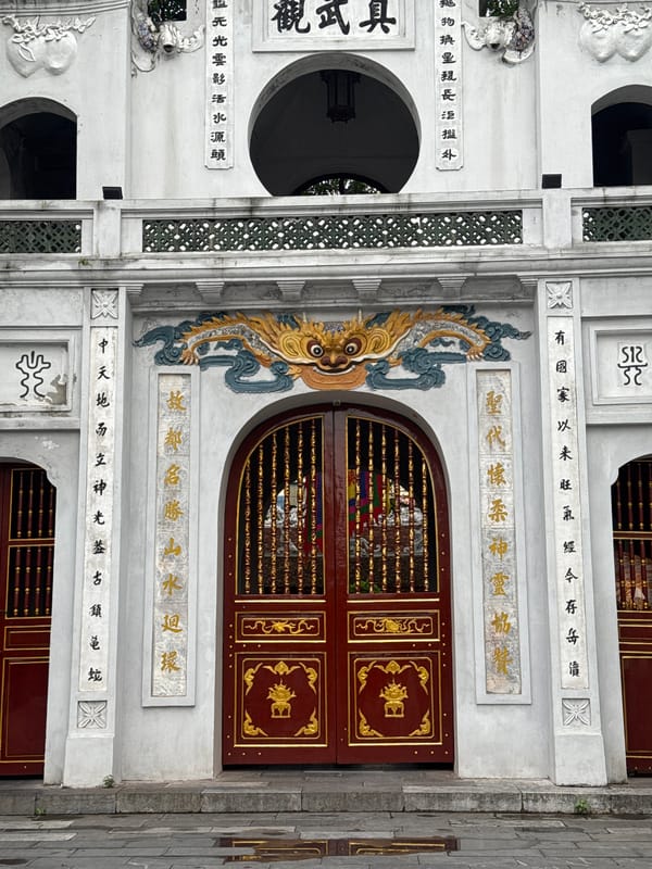 Temple gates, street traffic, and park life in central Hanoi