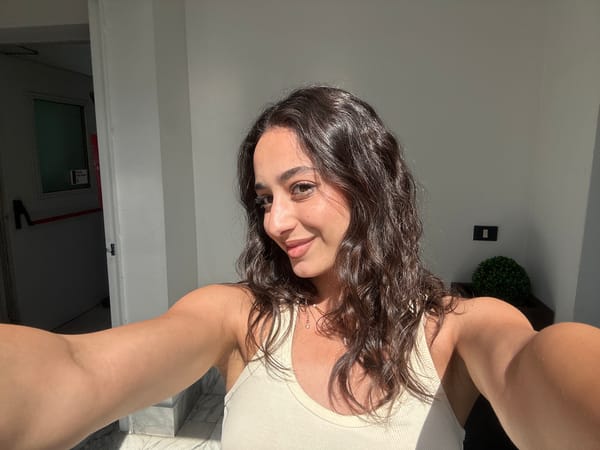 Woman takes selfies in Milan building interior