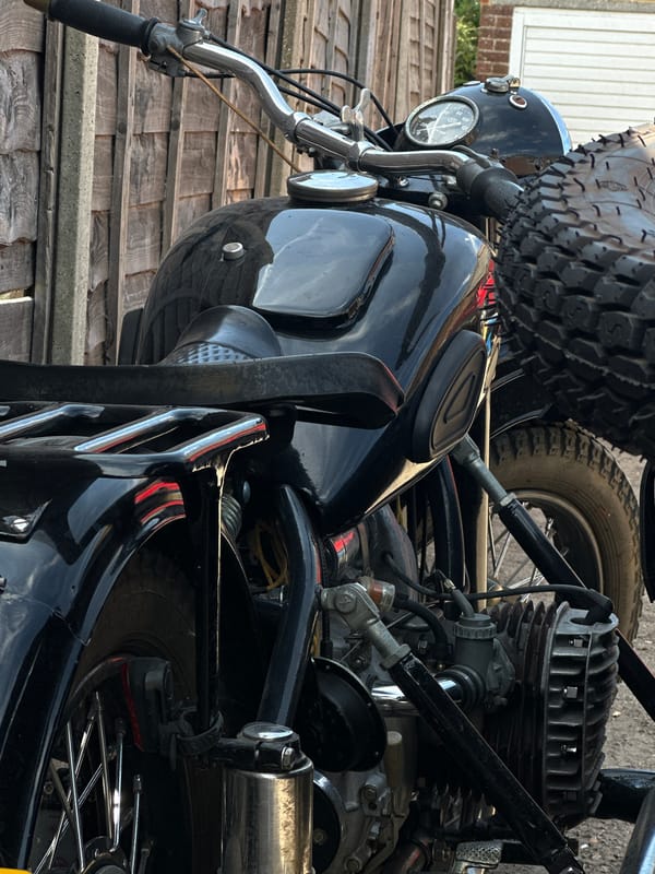 Low-angle detail shots of a vintage black motorcycle with sidecar