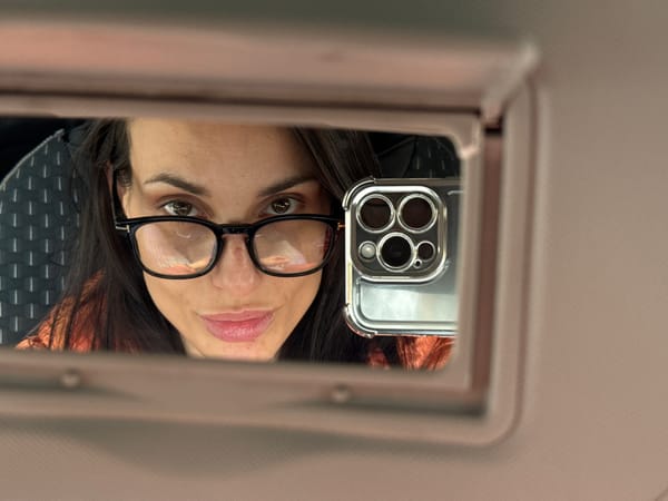 Woman takes selfie using car visor mirror in Bulgaria