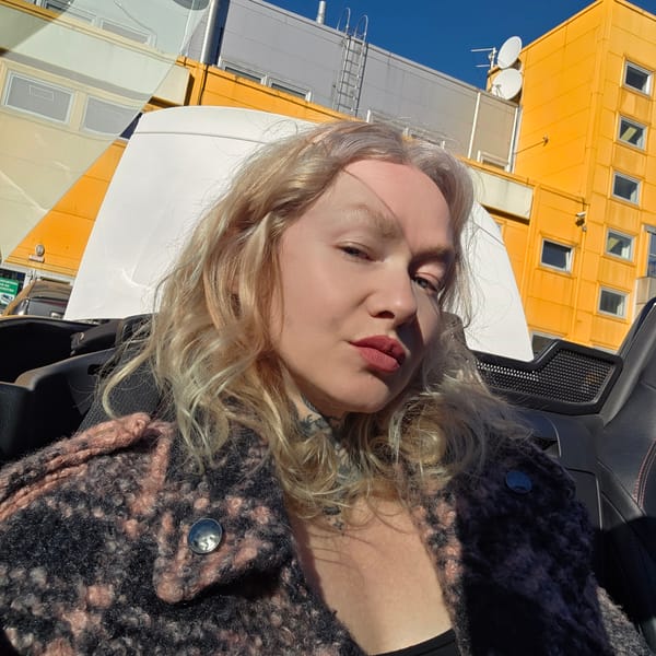 Woman takes selfie in car driver's seat in Saint Petersburg