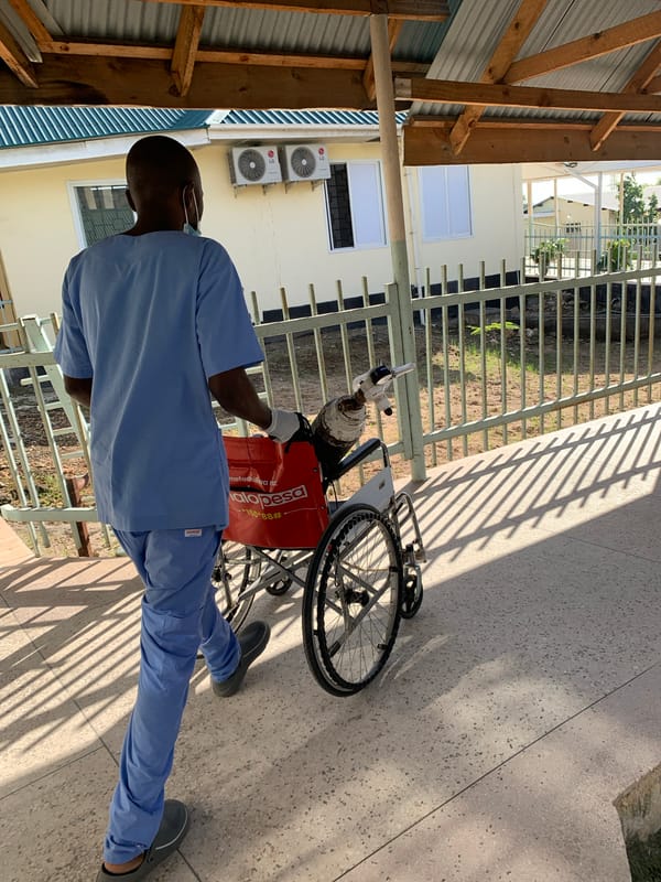 Medical worker transports patient with oxygen at Dar es Salaam facility