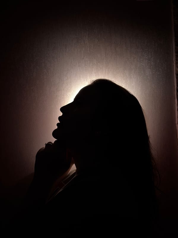 Person with phone observed in dimly lit room