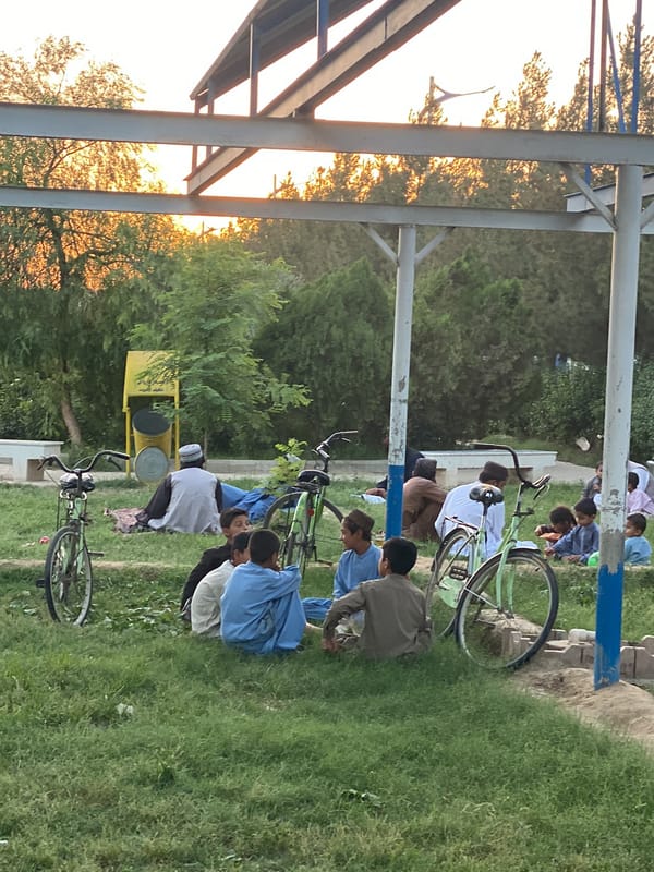 Outdoor gathering observed in Kandahar during golden hour lighting