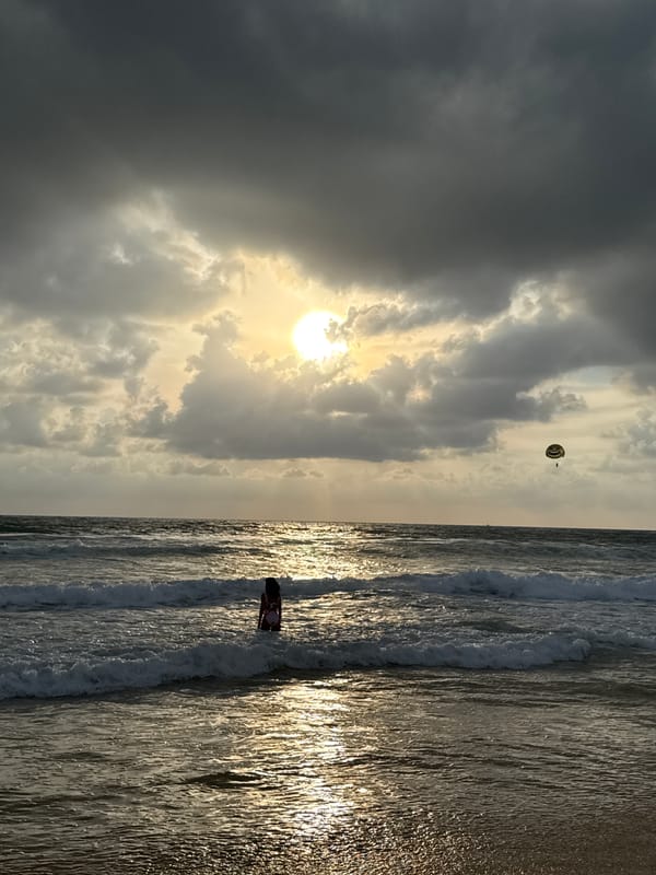 Karon Beach under stormy skies with sun breaking through