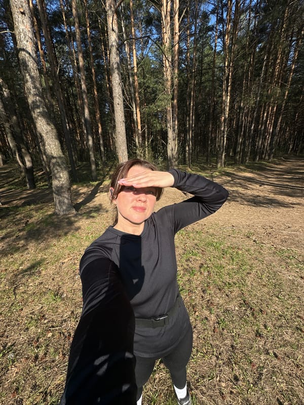 Person rests in forest near power lines in Chaikovsky