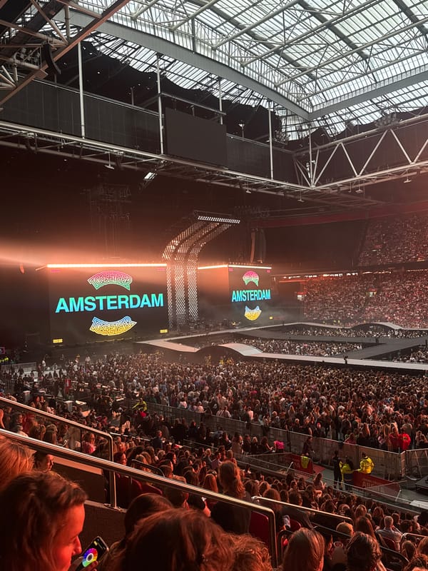 Crowd gathers at Amsterdam stadium event with branded displays