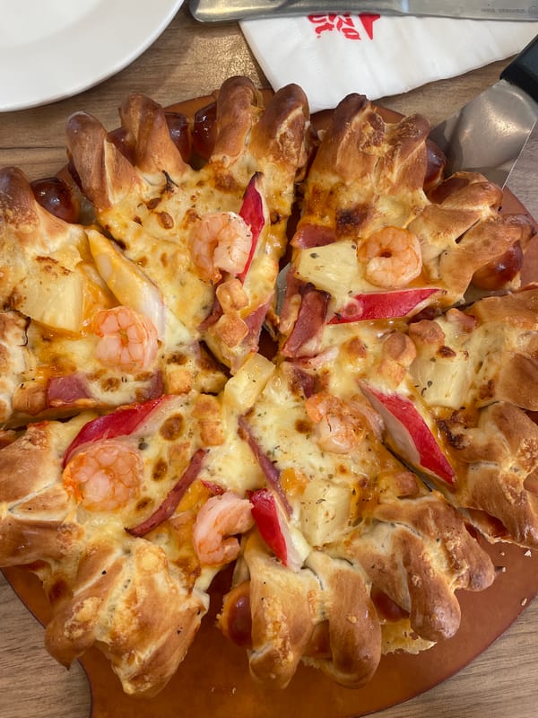 Woman dines at pizza restaurant in Tambon Fa Ham